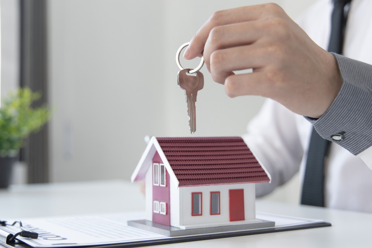 Model house with mortgage paperwork representing VA loan credit requirements